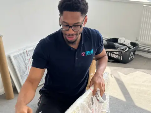 MET Removals packer wrapping a household item in bubble wrap, packing services in Chigwell